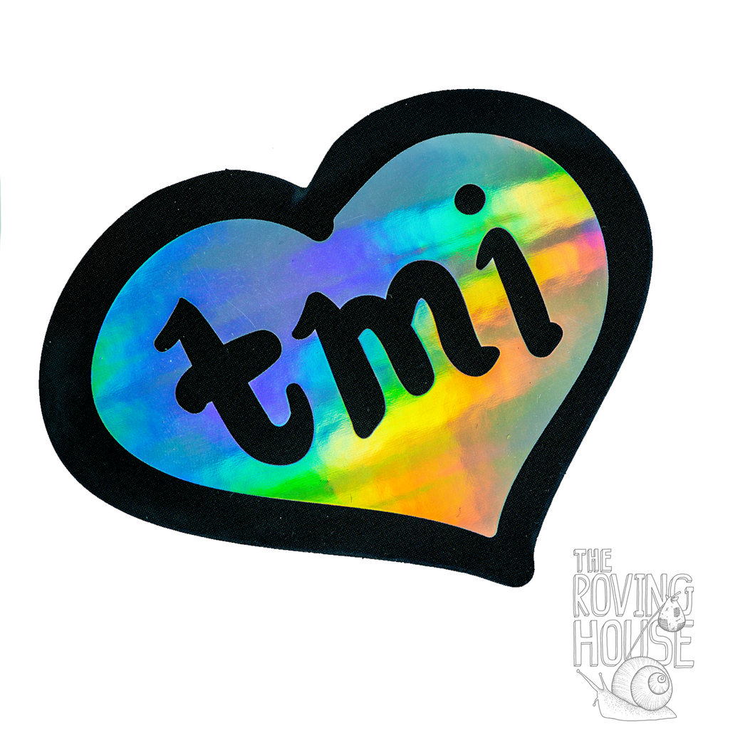 A holographic sticker of a heart with the text 