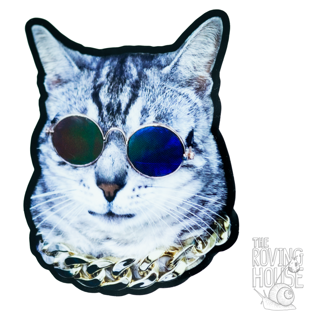 A sticker featuring the head of a grey striped cat wearing sunglasses and a chain.